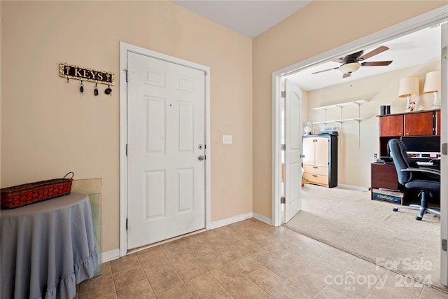 carpeted office space featuring ceiling fan