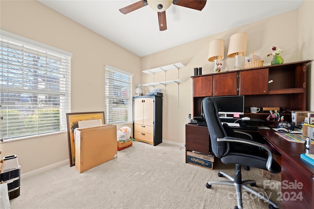 carpeted office featuring plenty of natural light and ceiling fan