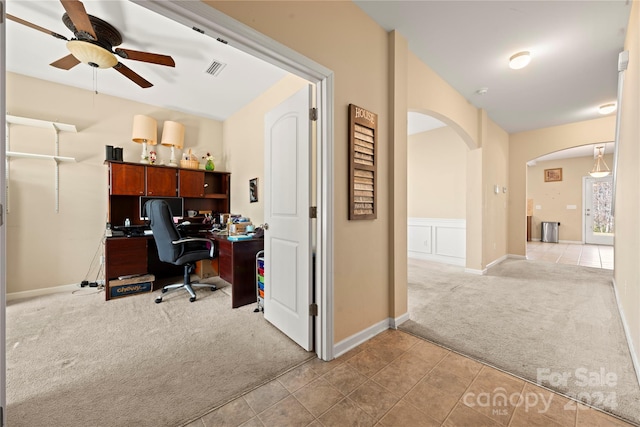 carpeted home office with ceiling fan