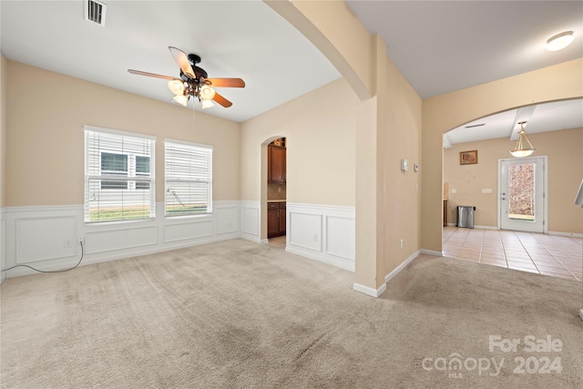 carpeted empty room with ceiling fan