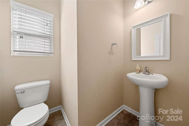 bathroom featuring tile patterned flooring, toilet, and sink