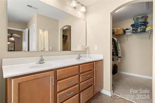 bathroom with tile patterned floors, ceiling fan, and vanity