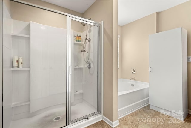 bathroom with separate shower and tub and tile patterned flooring