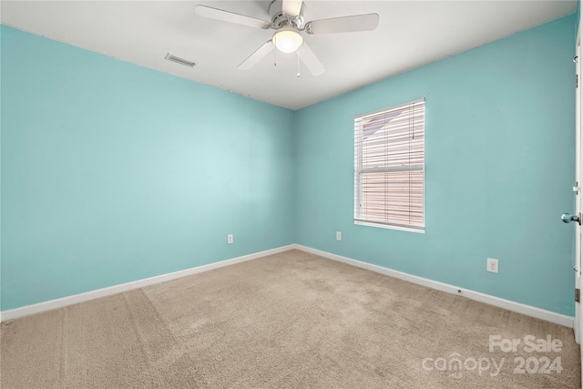 empty room featuring carpet flooring and ceiling fan