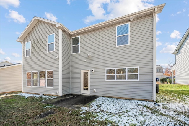 snow covered property with a yard and cooling unit