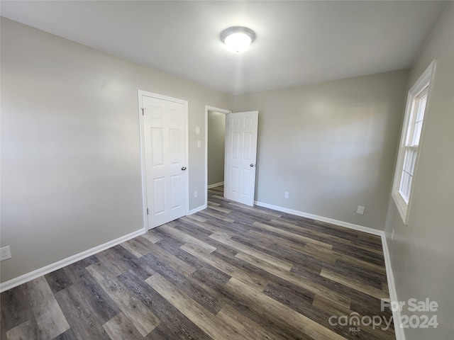 spare room with dark hardwood / wood-style floors