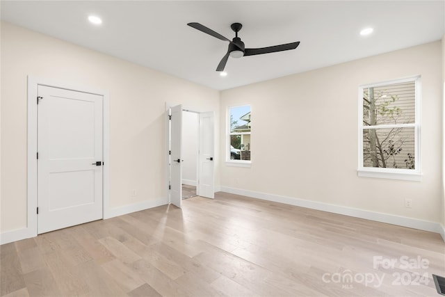 spare room featuring ceiling fan and light wood-type flooring