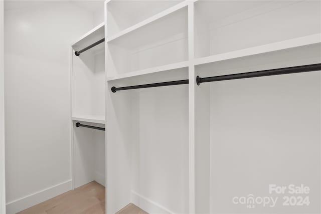 spacious closet featuring light hardwood / wood-style floors