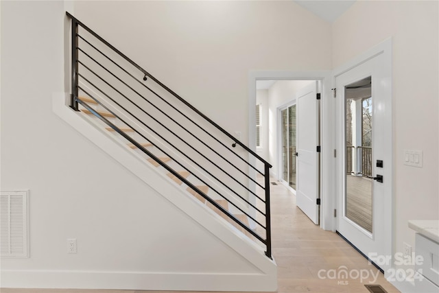 stairs featuring wood-type flooring