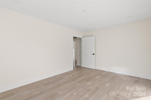 unfurnished room with light hardwood / wood-style flooring