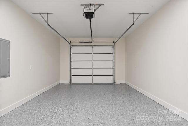 garage with electric panel and a garage door opener