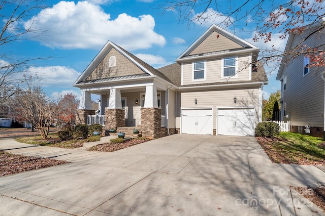 craftsman inspired home featuring covered porch and a garage