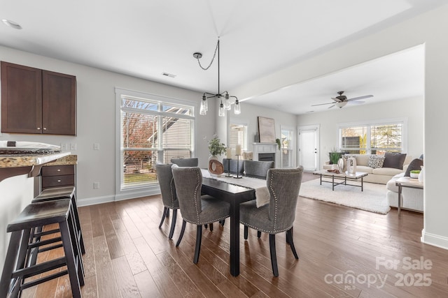 dining room featuring dark hardwood / wood-style floors and ceiling fan