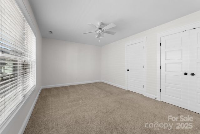 unfurnished bedroom featuring carpet flooring and ceiling fan