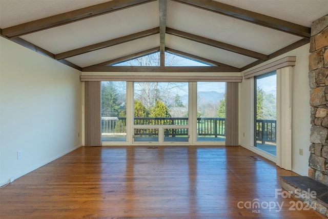 208 Dogwood Ln, Black Mountain, NC 28711 - unfurnished living room featuring hardwood / wood-style flooring and lofted ceiling with beams