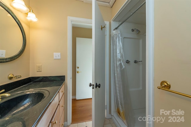 208 Dogwood Ln, Black Mountain, NC 28711 - bathroom featuring hardwood / wood-style flooring, vanity, and walk in shower