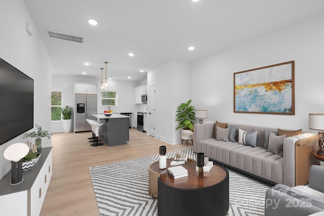 living room with light hardwood / wood-style flooring