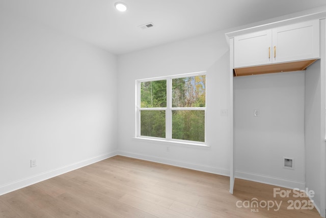 spare room featuring light wood-type flooring