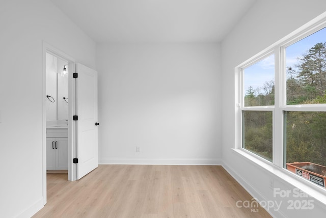 spare room with light hardwood / wood-style floors