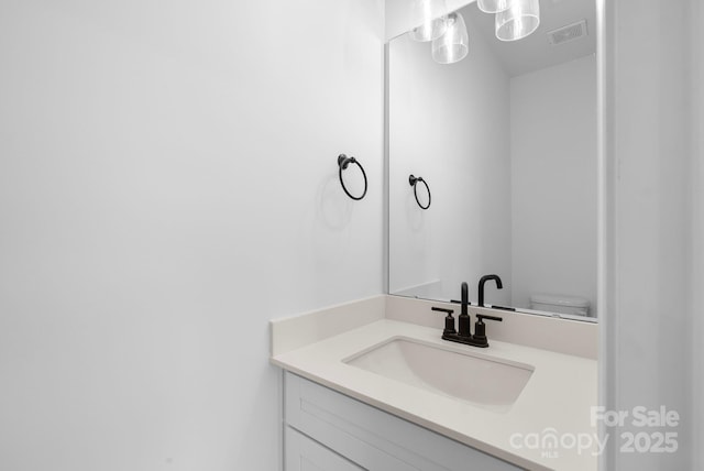 bathroom with vanity and toilet