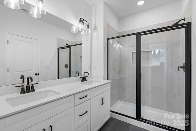 bathroom with vanity, an enclosed shower, and tile patterned floors