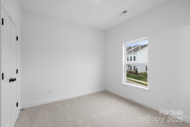 empty room featuring light carpet