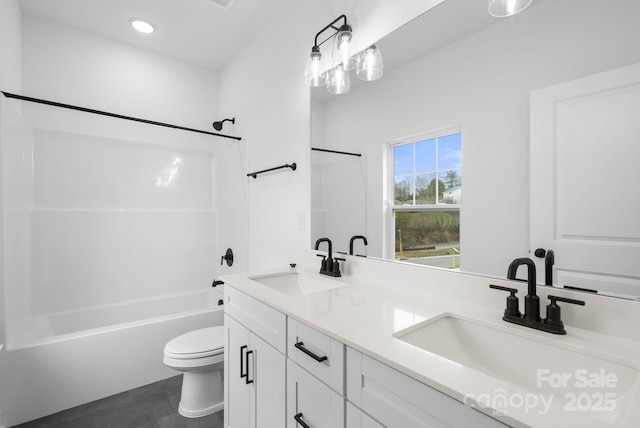 full bathroom with shower / bathing tub combination, vanity, and toilet