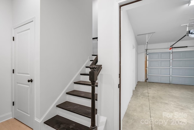 stairway with concrete flooring