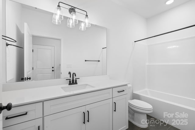 full bathroom with shower / tub combination, vanity, and toilet