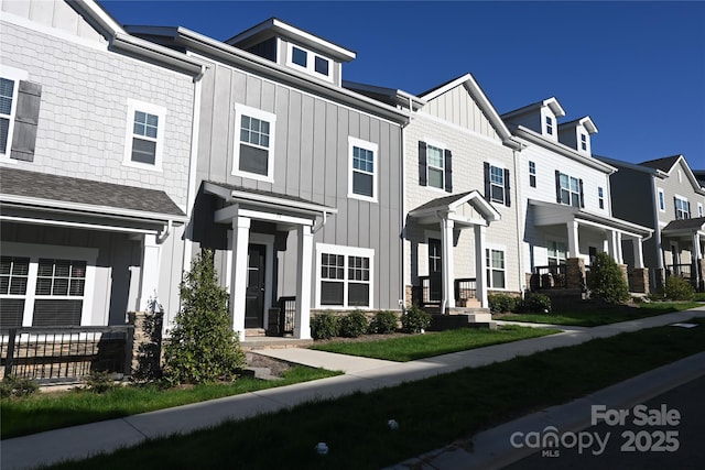 multi unit property with board and batten siding and a residential view