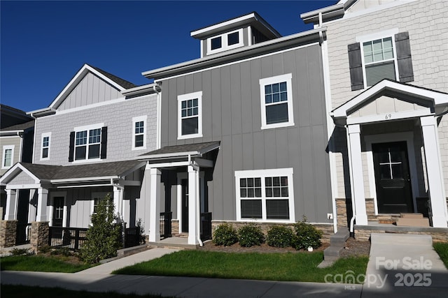 townhome / multi-family property featuring board and batten siding and stone siding