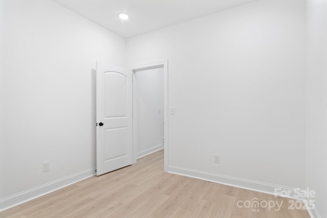 empty room with light hardwood / wood-style flooring