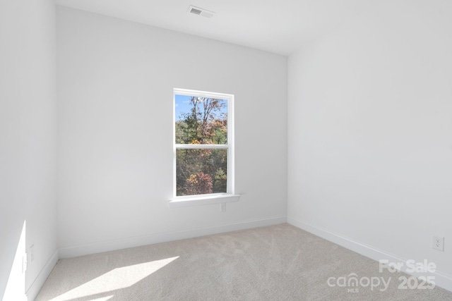 unfurnished room with light carpet