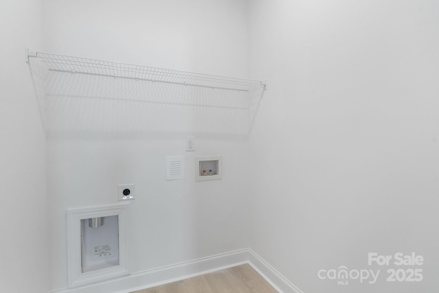 washroom featuring washer hookup, hookup for an electric dryer, and light hardwood / wood-style floors