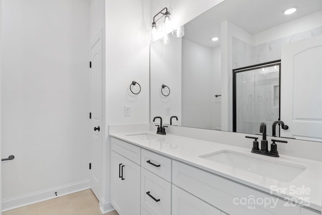 bathroom featuring vanity, tile patterned flooring, and a shower with door