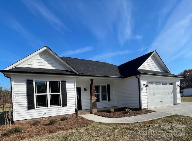 single story home featuring a porch and a garage