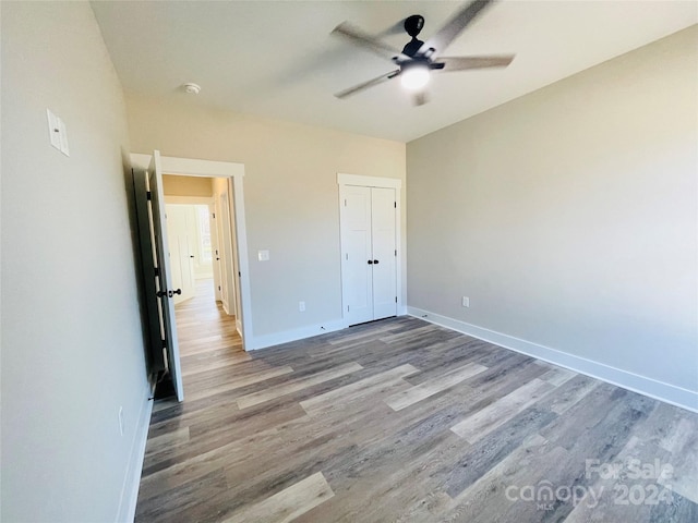 unfurnished bedroom featuring ceiling fan and light hardwood / wood-style flooring