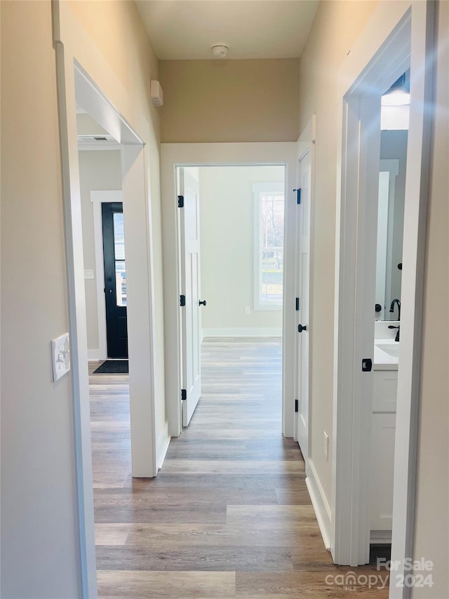 hallway with light hardwood / wood-style flooring