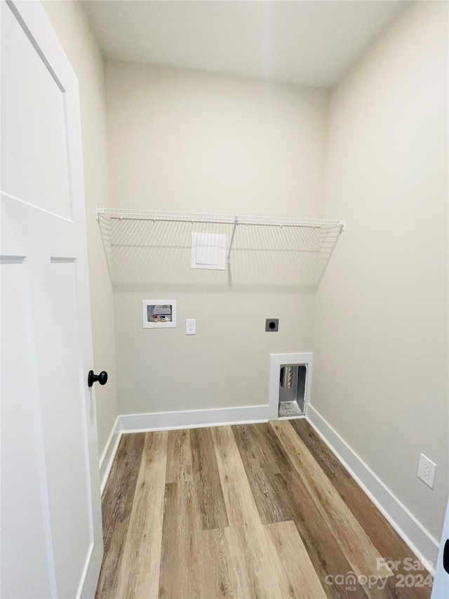 laundry area with hookup for a washing machine, light hardwood / wood-style flooring, and hookup for an electric dryer