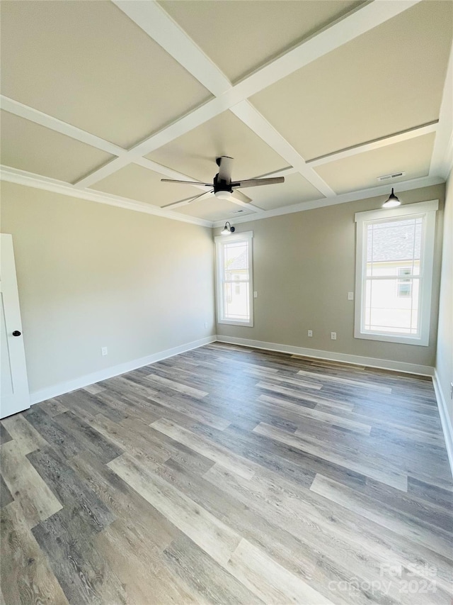 empty room with light hardwood / wood-style floors, ceiling fan, and coffered ceiling