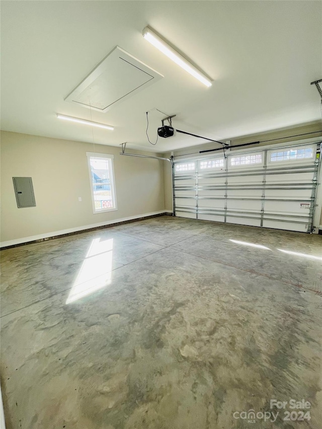 garage featuring electric panel and a garage door opener