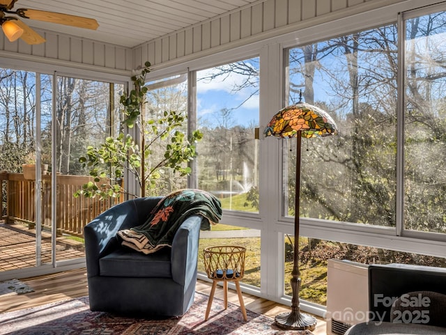 sunroom / solarium featuring ceiling fan