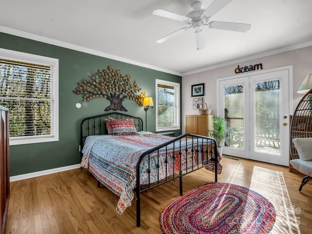 bedroom with ceiling fan, hardwood / wood-style floors, multiple windows, and access to outside