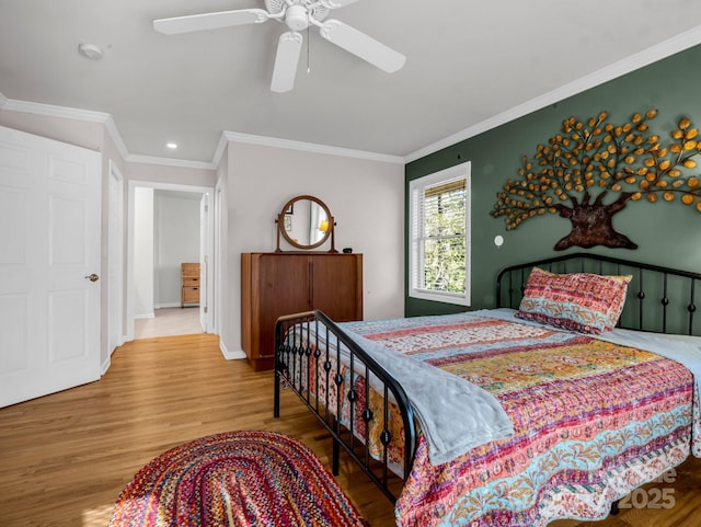 bedroom with ornamental molding, hardwood / wood-style floors, and ceiling fan