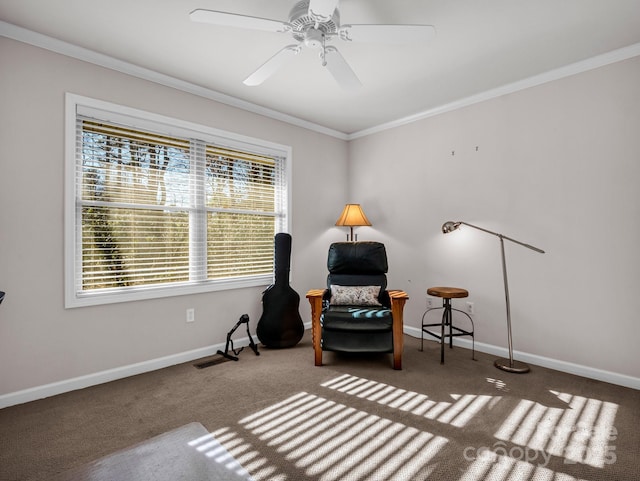 sitting room featuring crown molding, plenty of natural light, ceiling fan, and dark carpet