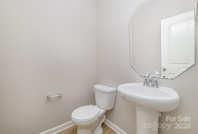 bathroom with sink, tile patterned flooring, and toilet