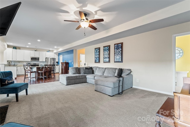 living room featuring ceiling fan and carpet floors