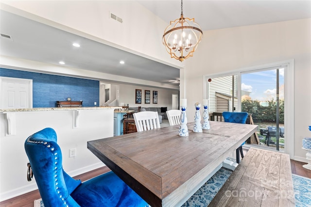 dining room featuring dark hardwood / wood-style flooring and an inviting chandelier