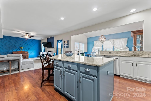 kitchen with ceiling fan, sink, pendant lighting, dishwasher, and white cabinetry