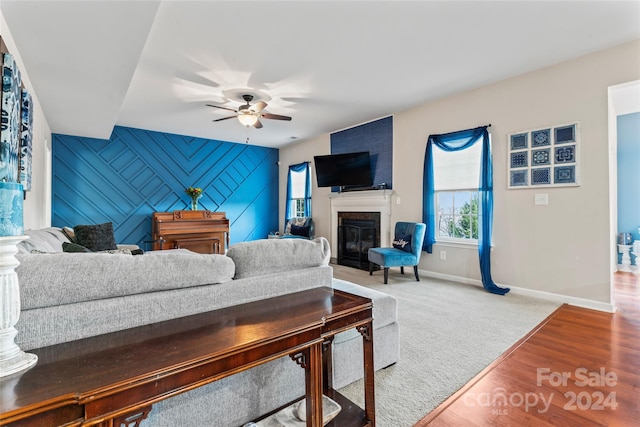 living room featuring ceiling fan and hardwood / wood-style floors